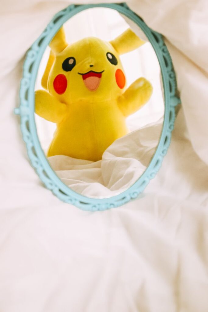 Adorable Pikachu plush reflected in a vintage mirror, adding a playful touch to decor.